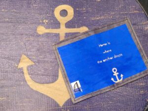 black mini wallet "home is where the anchor drops"